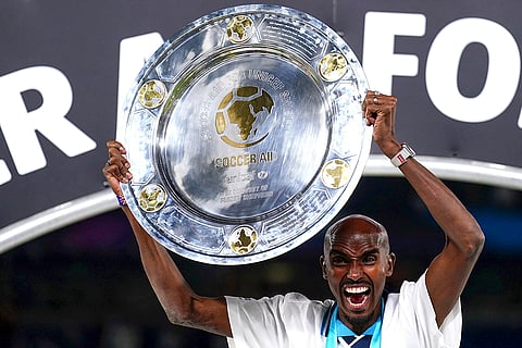 Mo Farah celebrates with trophy